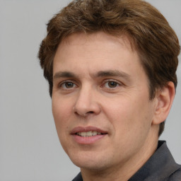 Joyful white adult male with short  brown hair and brown eyes