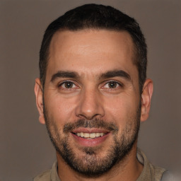 Joyful white adult male with short  brown hair and brown eyes