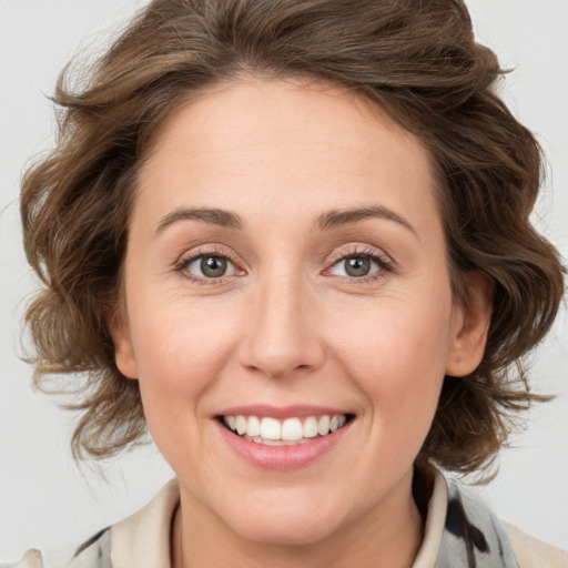 Joyful white young-adult female with medium  brown hair and blue eyes