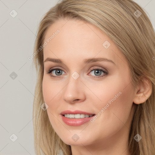 Joyful white young-adult female with long  brown hair and blue eyes