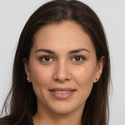 Joyful white young-adult female with long  brown hair and brown eyes