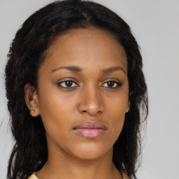 Joyful black young-adult female with long  brown hair and brown eyes