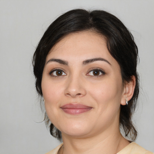 Joyful white young-adult female with medium  black hair and brown eyes