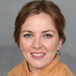 Joyful white adult female with medium  brown hair and blue eyes