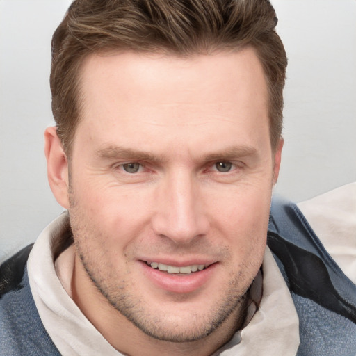 Joyful white adult male with short  brown hair and grey eyes