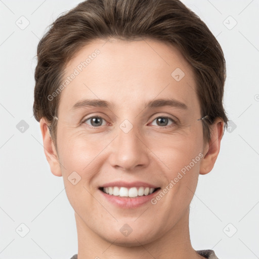 Joyful white young-adult female with short  brown hair and grey eyes