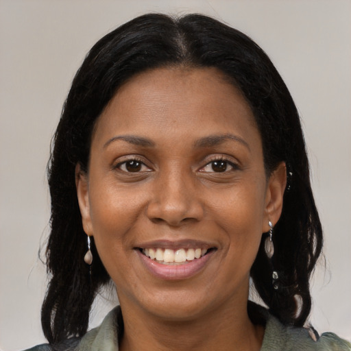 Joyful black young-adult female with medium  brown hair and brown eyes