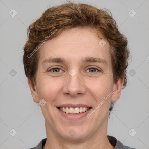 Joyful white adult male with short  brown hair and grey eyes