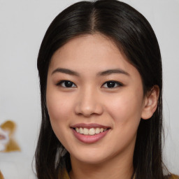 Joyful asian young-adult female with long  brown hair and brown eyes