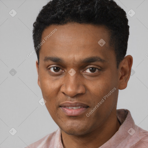 Joyful black young-adult male with short  black hair and brown eyes