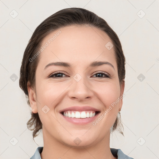 Joyful white young-adult female with medium  brown hair and grey eyes