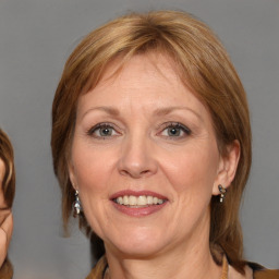 Joyful white adult female with medium  brown hair and grey eyes