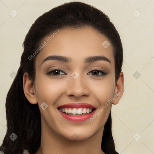 Joyful latino young-adult female with long  black hair and brown eyes