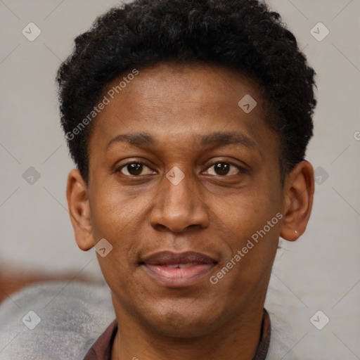 Joyful black adult male with short  brown hair and brown eyes