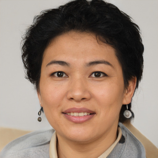 Joyful latino adult female with short  brown hair and brown eyes