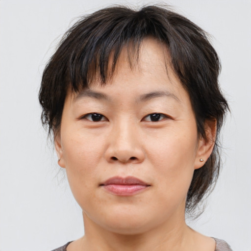 Joyful asian young-adult female with medium  brown hair and brown eyes