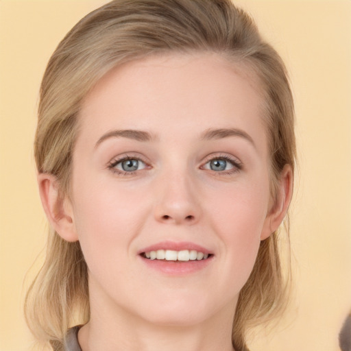 Joyful white young-adult female with medium  brown hair and grey eyes