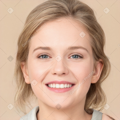 Joyful white young-adult female with medium  brown hair and blue eyes