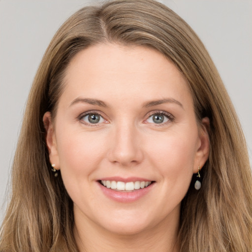 Joyful white young-adult female with long  brown hair and grey eyes