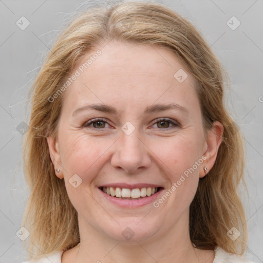 Joyful white young-adult female with medium  brown hair and blue eyes