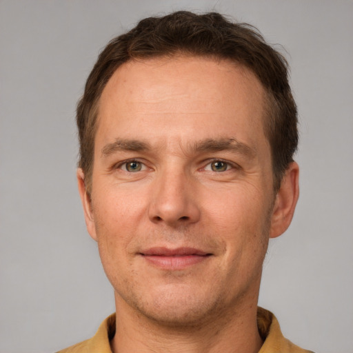 Joyful white adult male with short  brown hair and grey eyes