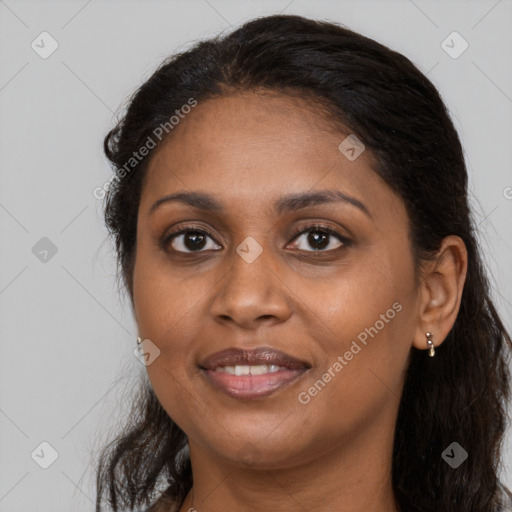 Joyful black adult female with long  brown hair and brown eyes