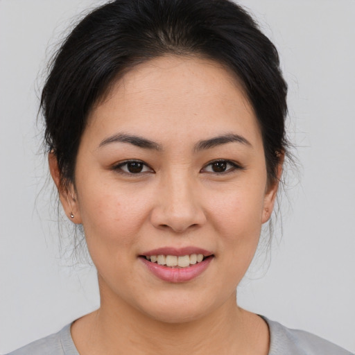 Joyful asian young-adult female with medium  brown hair and brown eyes