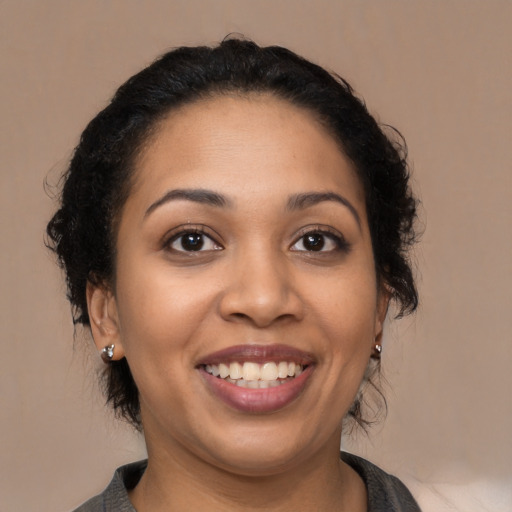 Joyful latino young-adult female with medium  black hair and brown eyes