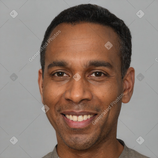 Joyful latino adult male with short  black hair and brown eyes