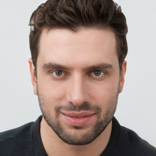 Joyful white young-adult male with short  brown hair and grey eyes