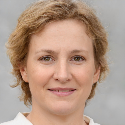 Joyful white adult female with medium  brown hair and blue eyes