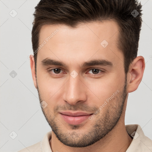 Joyful white young-adult male with short  brown hair and brown eyes