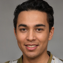 Joyful white young-adult male with short  black hair and brown eyes