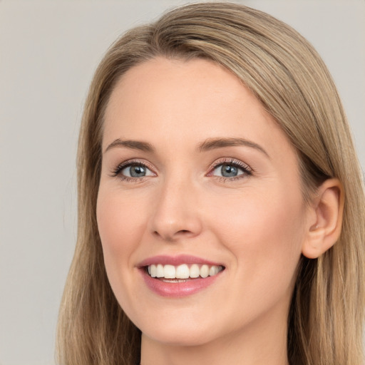 Joyful white young-adult female with long  brown hair and blue eyes