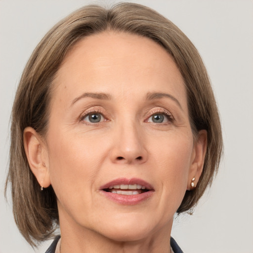 Joyful white adult female with medium  brown hair and grey eyes