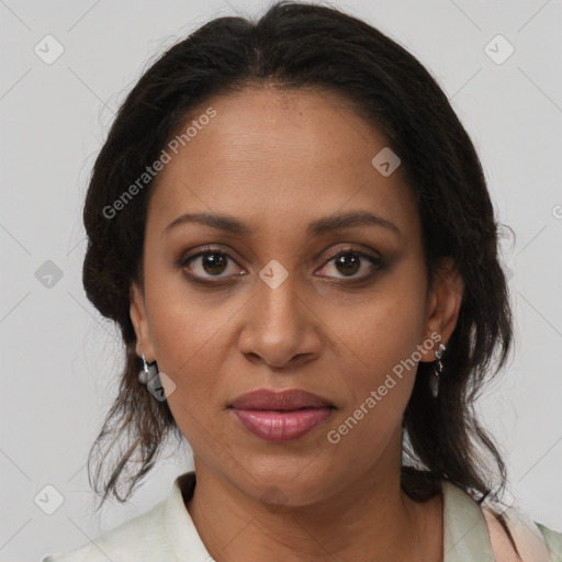 Joyful black adult female with medium  brown hair and brown eyes