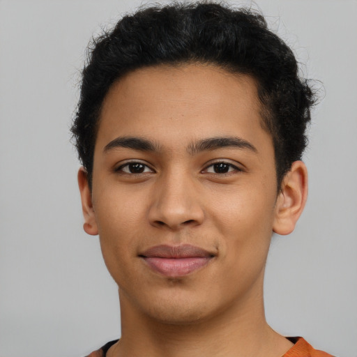 Joyful latino young-adult male with short  brown hair and brown eyes