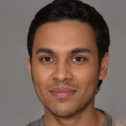 Joyful white young-adult male with short  black hair and brown eyes