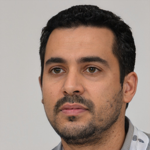Neutral latino young-adult male with short  black hair and brown eyes
