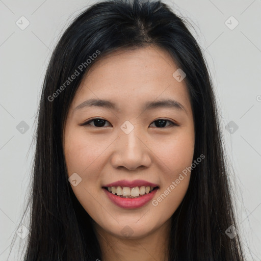 Joyful asian young-adult female with long  brown hair and brown eyes