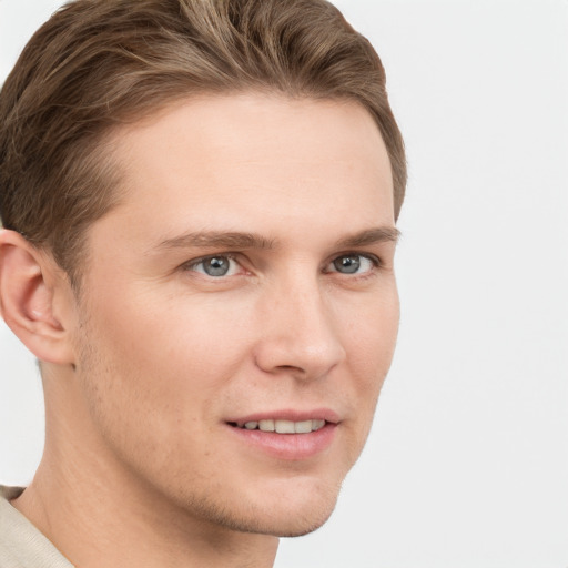 Joyful white young-adult male with short  brown hair and grey eyes