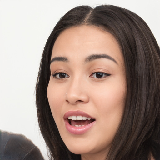 Joyful white young-adult female with long  black hair and brown eyes