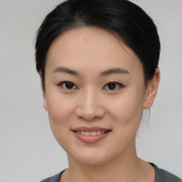 Joyful asian young-adult female with short  brown hair and brown eyes