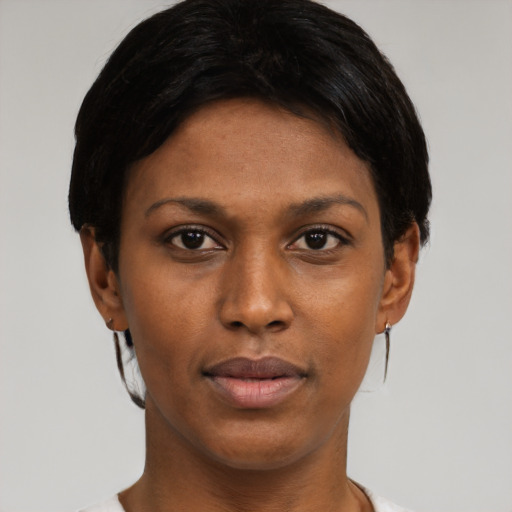 Joyful black young-adult female with short  black hair and brown eyes