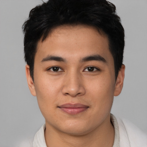 Joyful asian young-adult male with short  brown hair and brown eyes