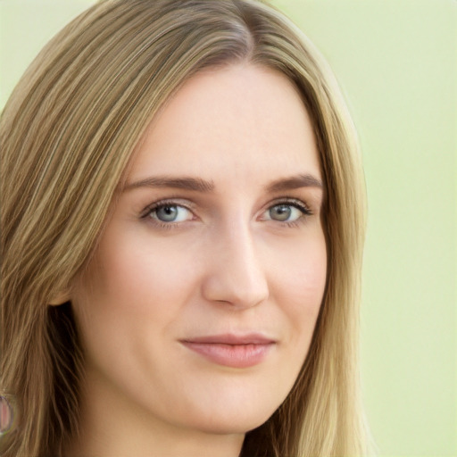 Joyful white young-adult female with long  brown hair and green eyes