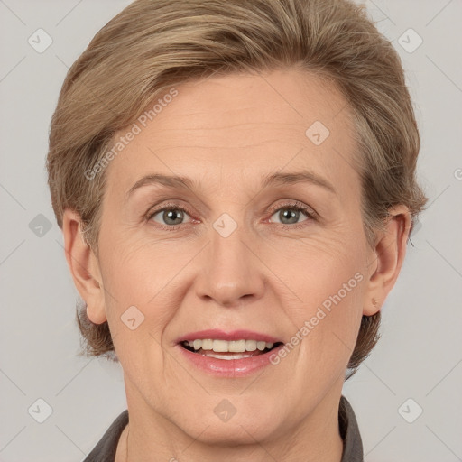 Joyful white adult female with medium  brown hair and grey eyes