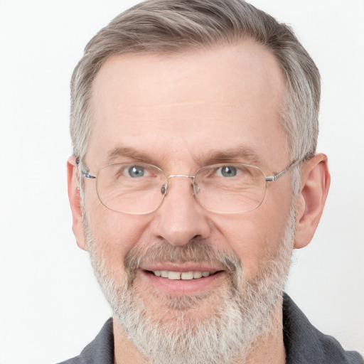 Joyful white middle-aged male with short  gray hair and blue eyes