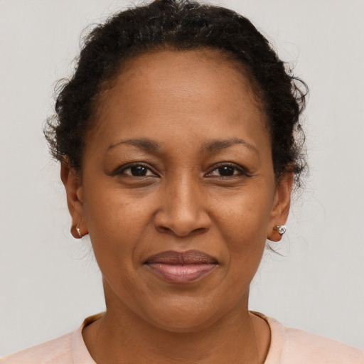 Joyful black adult female with short  brown hair and brown eyes