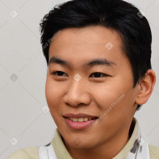 Joyful asian young-adult male with short  brown hair and brown eyes